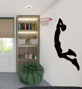 Basketball-themed bedroom corner in Bromley by Oraanj Interior Design, featuring a wall-mounted hoop, a built-in bookshelf, and a cosy green chair.