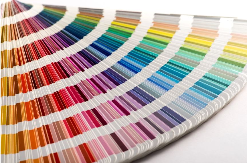 Colour swatch fan displaying a wide spectrum of paint colours arranged in a gradient for design selection.