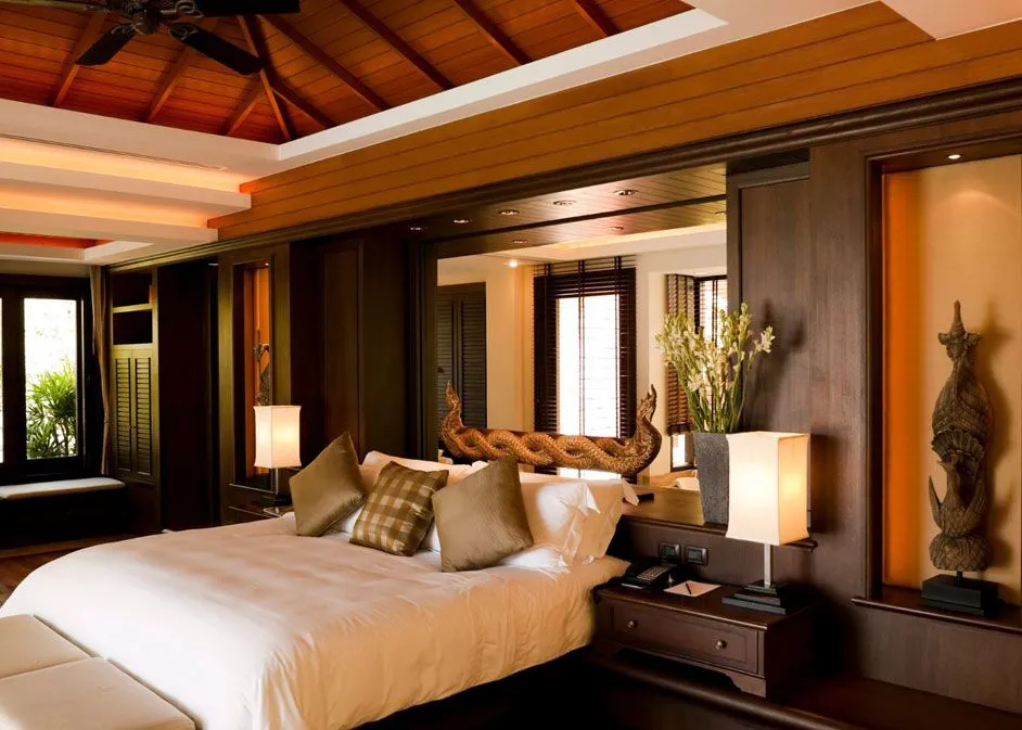 Minimalist modern bedroom featuring sleek furniture, a statement rug, and green plants for a refreshing vibe.