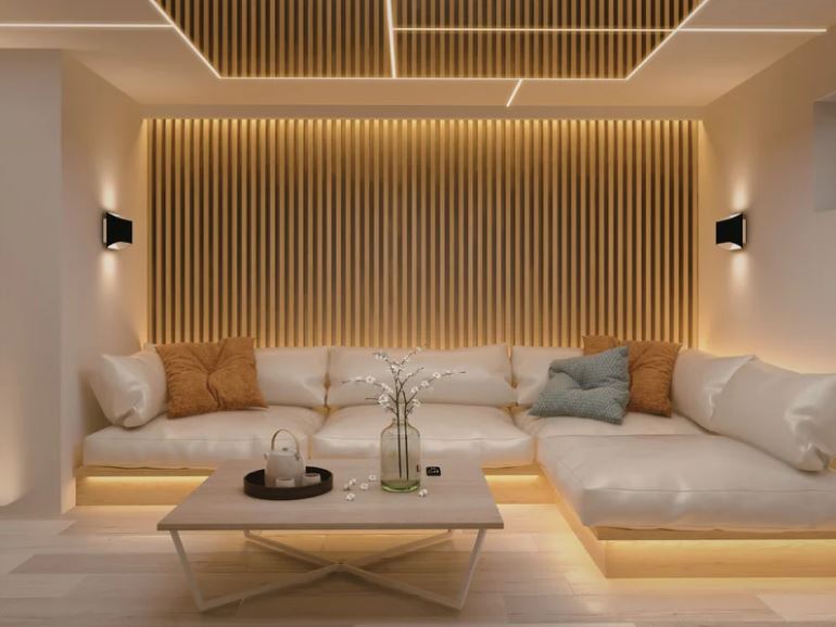 Modern lounge seating area with built-in sofa, vertical wooden slat feature wall, integrated LED lighting, and a warm neutral palette.