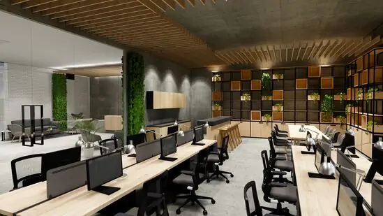 Modern UK office design with open workspace, ergonomic chairs, wooden desks, and green wall features.