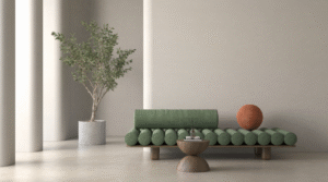 A minimalist living space featuring a sculptural green sofa with rounded cushions, a small pedestal coffee table, an accent sphere cushion, a potted tree, and soft neutral walls.