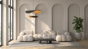 A minimalist living room with sculptural cloud-like sofas, arched wall panelling, a low coffee table, modern pendant lighting, large windows, and indoor greenery.