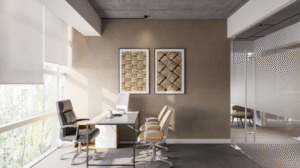 A modern private office with a desk, ergonomic chairs, framed wall art, glass partition walls, concrete ceiling, and large windows providing natural light.