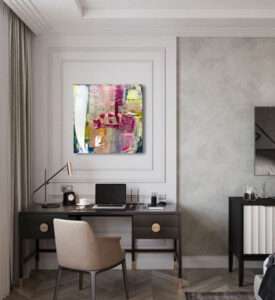 Modern home office with black desk laptop and abstract wall art