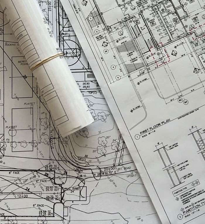 Architect desk with tablet displaying floor plans and drafting tools