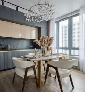 Modern kitchen and dining room with marble table and chandelier