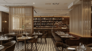 Modern restaurant interior with brown leather chairs, round and rectangular wooden tables set for dining, patterned tile floor, wooden slat partitions, and a wine‑display bar with pendant lighting.