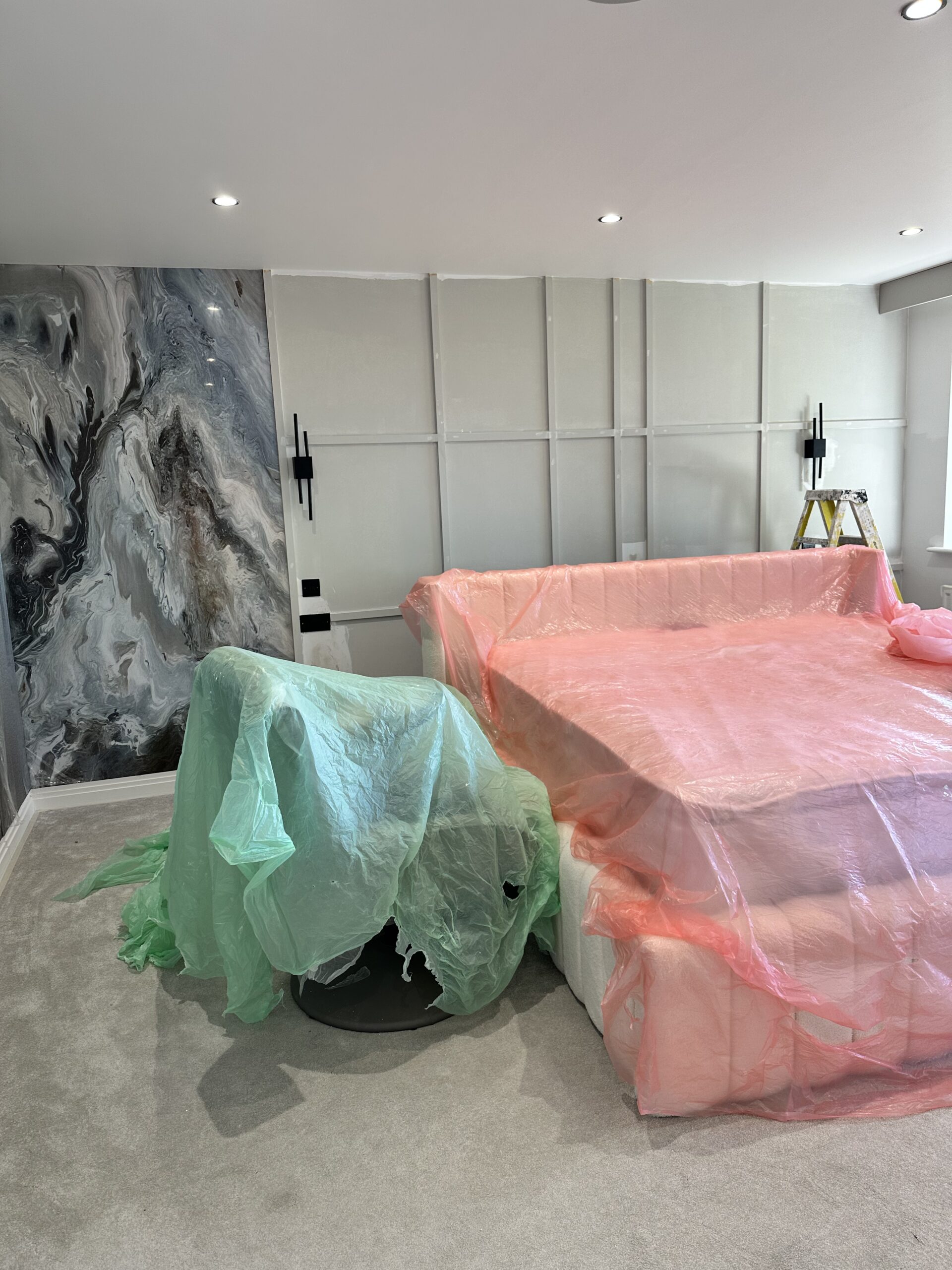 Luxury Home Office and Executive Lounge Design A 3D interior render of a luxury executive home office featuring wood-paneled walls, marble coffee tables, plush grey sofas, and modern circular halo chandeliers.