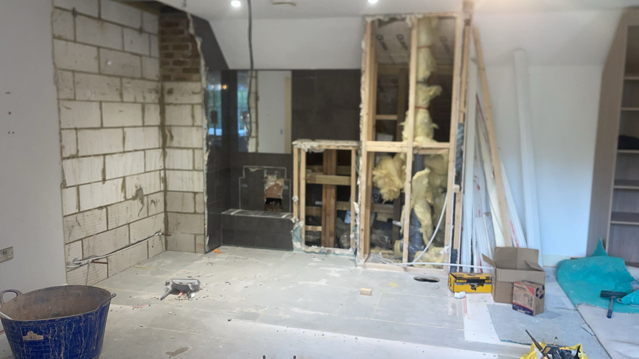 Residential Interior Shell and Core Construction Works An interior room under heavy construction showing exposed blockwork, timber stud partitioning, and insulation for a new bathroom or utility layout.