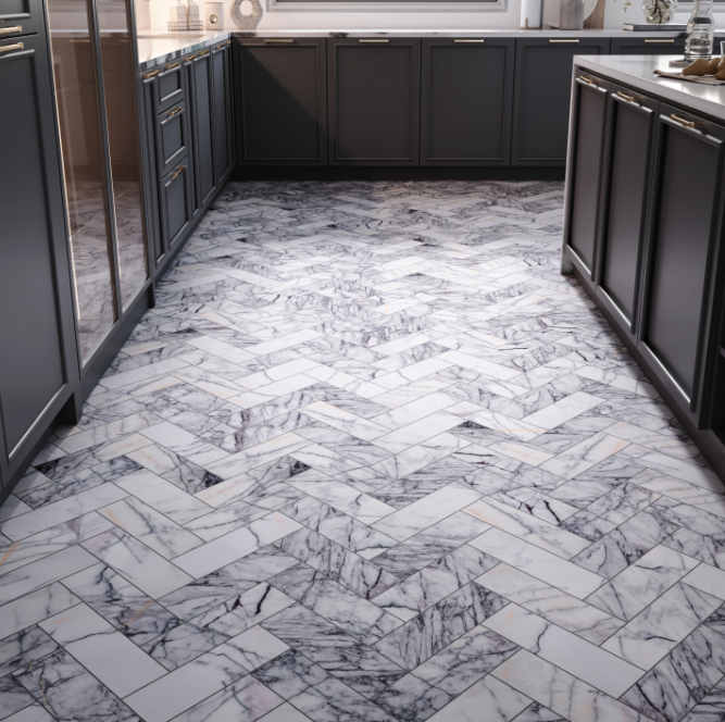 Luxury kitchen flooring featuring marble herringbone tiles paired with dark cabinetry, showcasing elegant stone flooring options for modern homes.