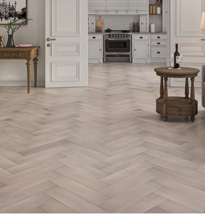 Soft oak herringbone flooring bringing warmth and texture to open-plan living spaces and kitchens.