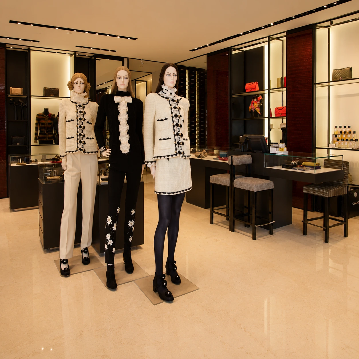 Luxury retail interior design with mannequins, premium displays, and elegant lighting in a high-end fashion boutique.