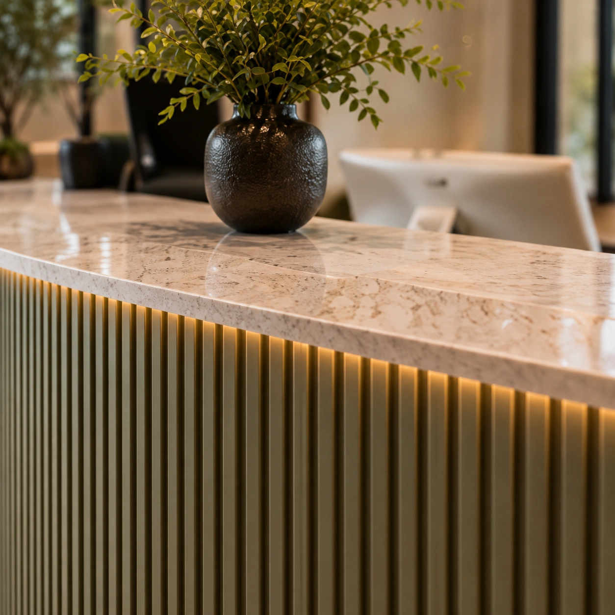 Reception desk with marble counter and olive panelling in Harrow clinic